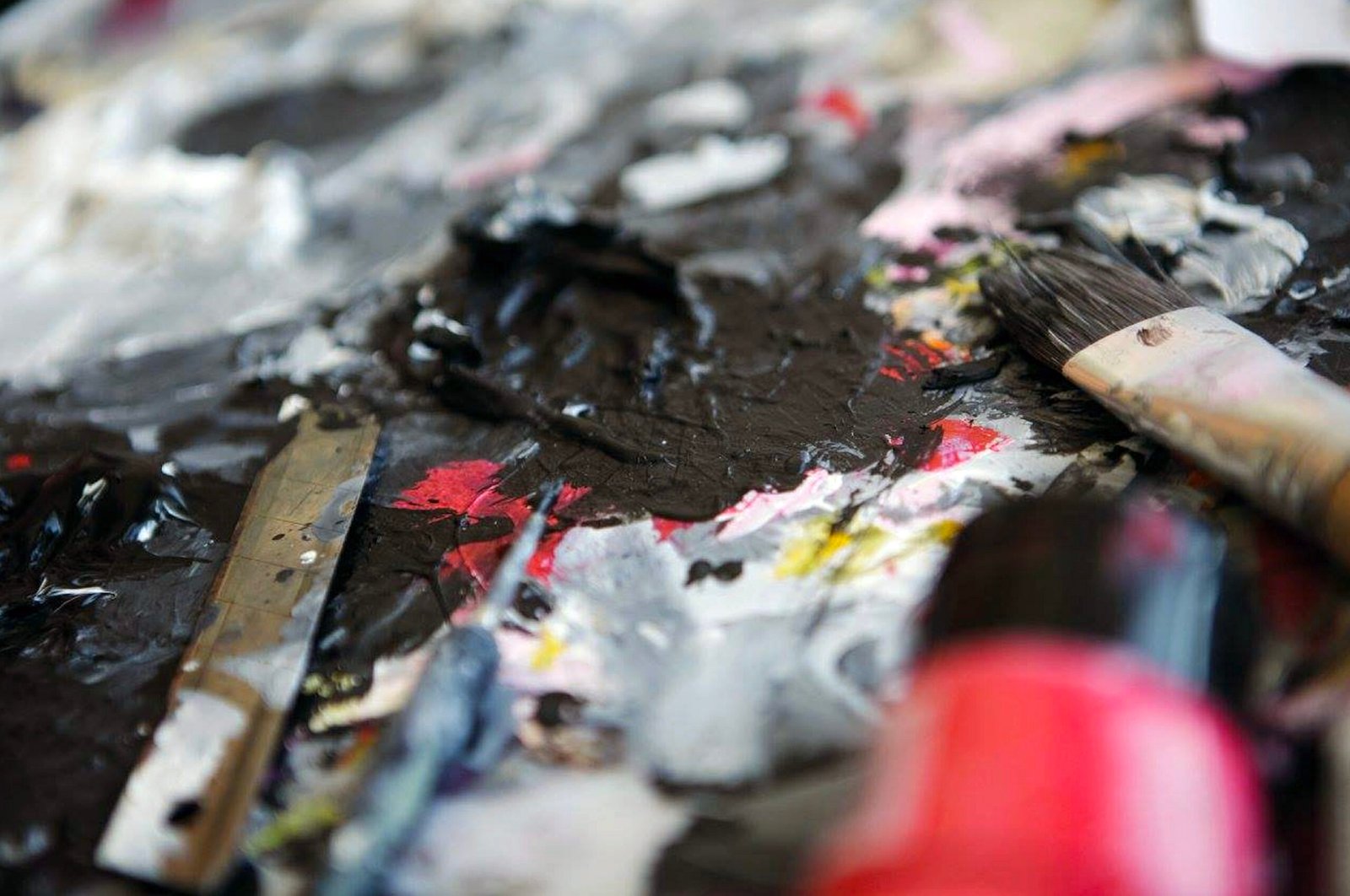 Paintbrushes and mixed pigments on an artist’s palette