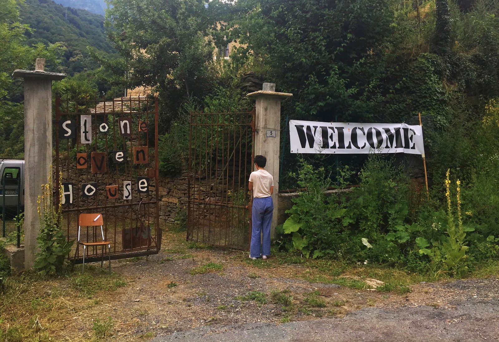 The Stone Oven House entrance with handmade lettering and a welcome banner