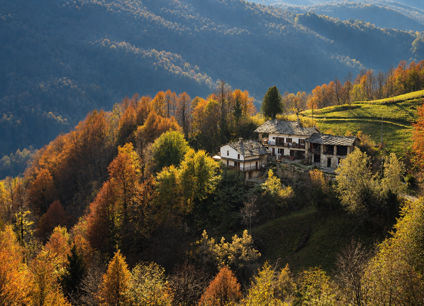 Stone Oven House with stone roofs and balconies surrounded by autumn trees