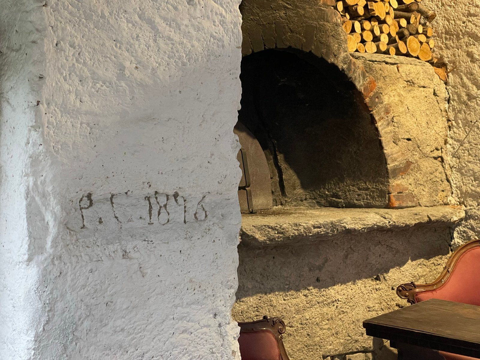 Carved date beside the old stone bread oven